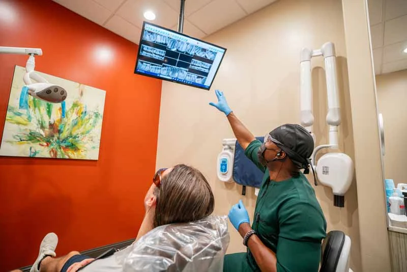 Dr. Abazie showing a patient their dental X-rays